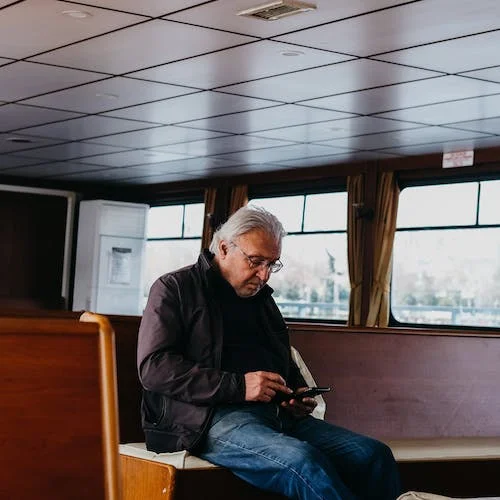 An Elderly Man Sitting on a Train