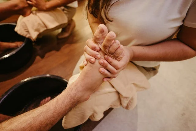 Woman Massaging Foot of a Man