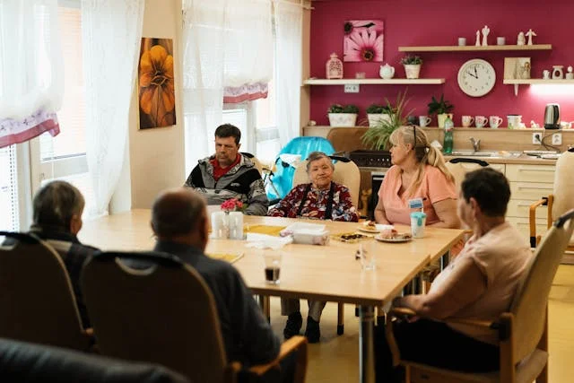 people in nursing home sitting on a table